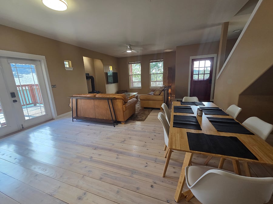 Open floor plan living, dining, and working areas.