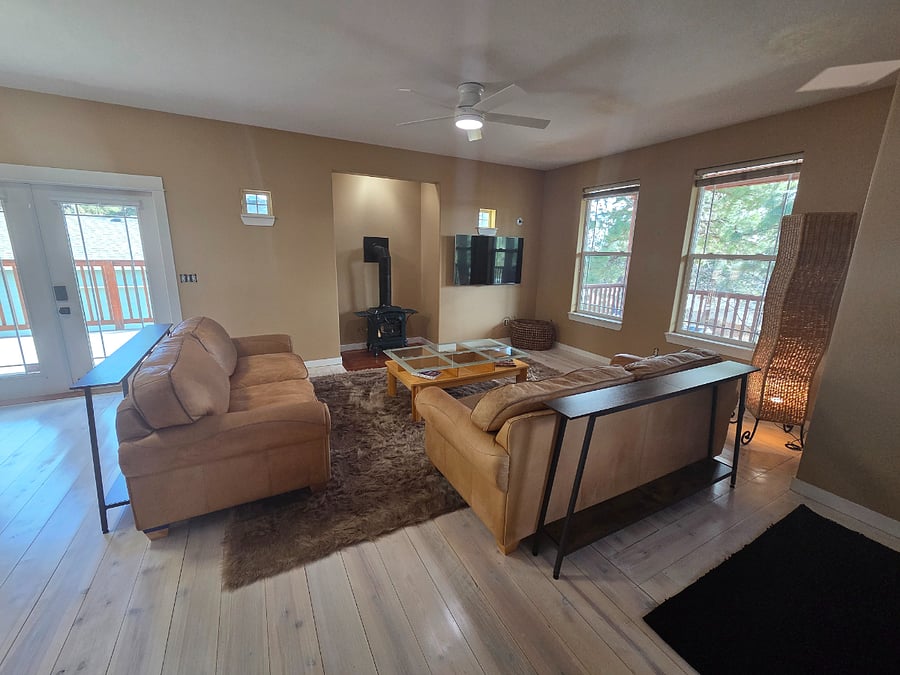 Living room with ambiance gas stove and swing-arm TV.