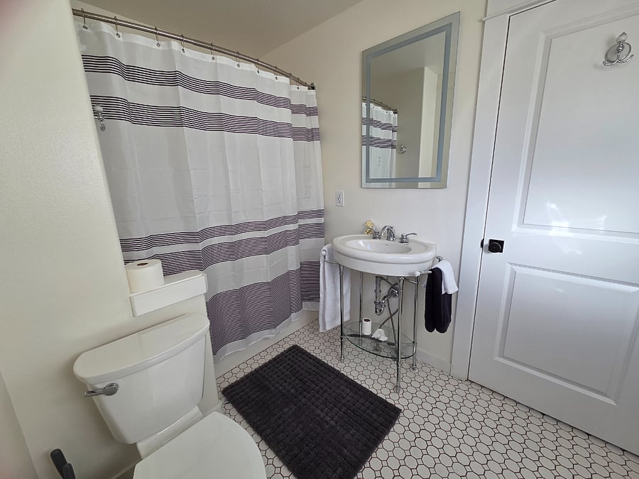 Full bathroom with tub and shower. Bedrooms 1 and 2 share.