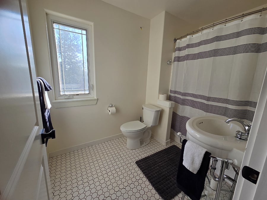 Full bathroom with tub and shower. Bedrooms 1 and 2 share.
