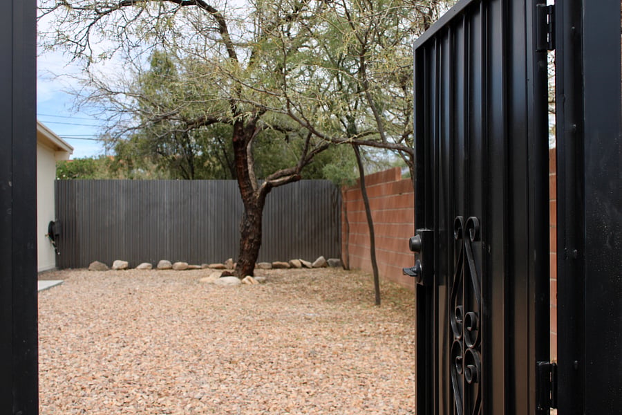 Large, shaded backyard and driveway.