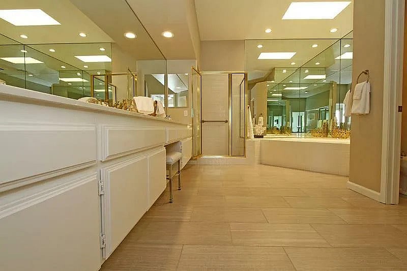 A spacious master bathroom with double vanities and mirrors