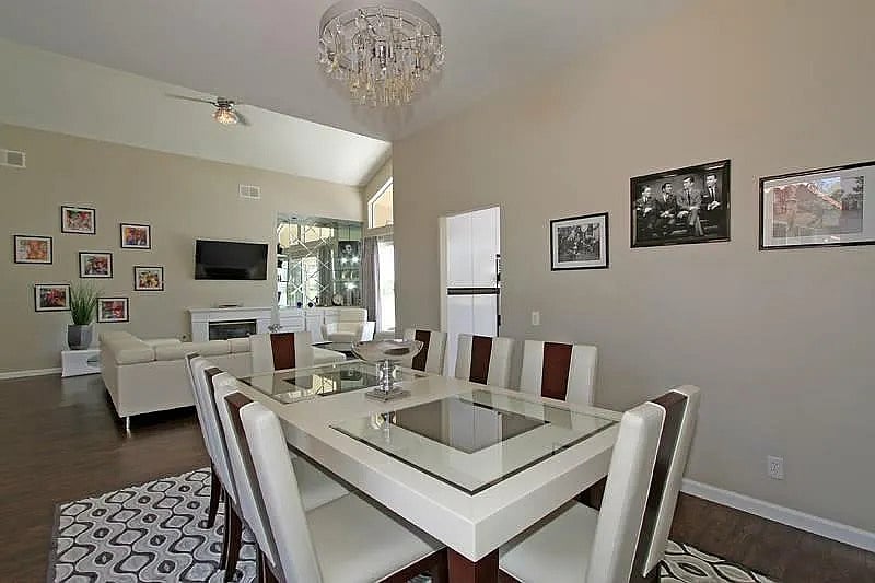 Pool view dining around the elegant glass dining table under a sparkling chandelier  perfect for memorable evenings with friends and family