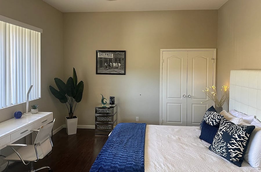 Work or unwind in this stylish bedroom featuring a dedicated workspace and pool view, because even paradise needs a little productivity corner