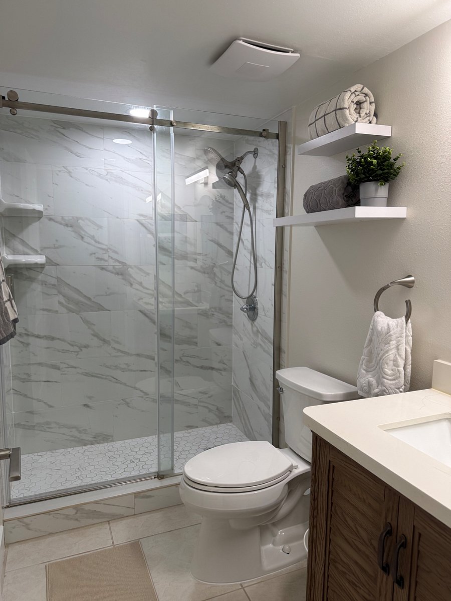 Main bathroom just off the guest room with single sink vanity and walk in shower. Both showers include shower head and hose set-up.