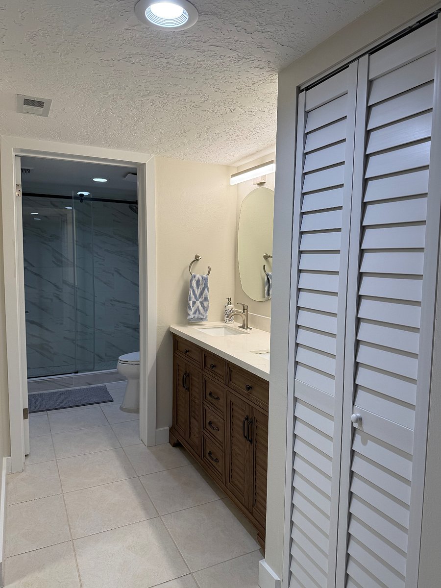En suite master bathroom with storage, double sinks and walk in shower with Bluetooth vent to hook up with music or podcasts while getting ready or showering.