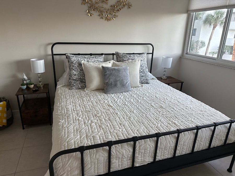 Main bedroom with new King bed and mattress with wall length windows for a beautiful view of the lush grounds and canal. Master bathroom in en suite.
