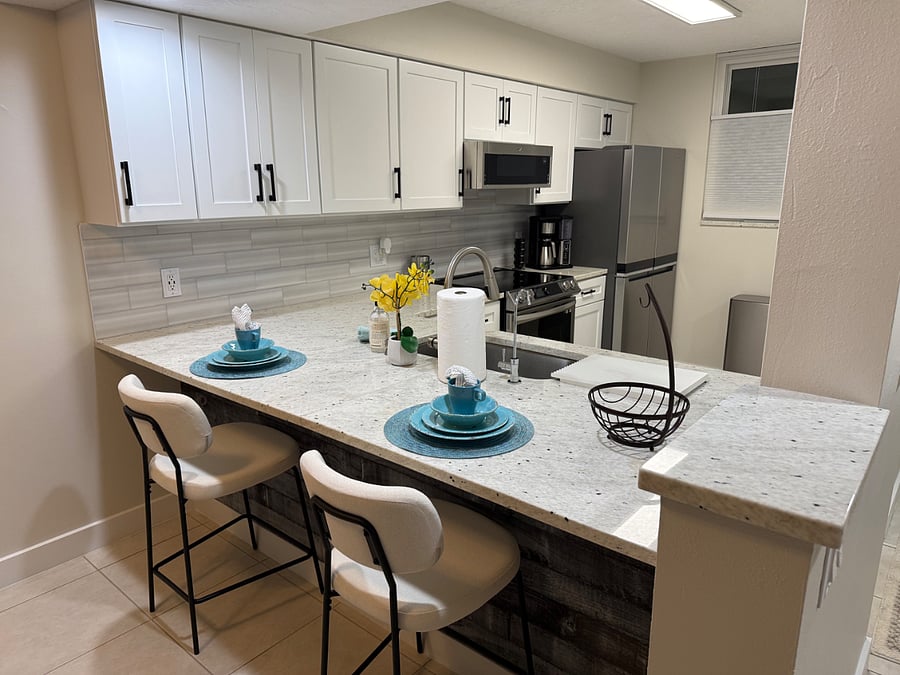 Fully equipped kitchen with all newer appliances including induction stovetop oven.