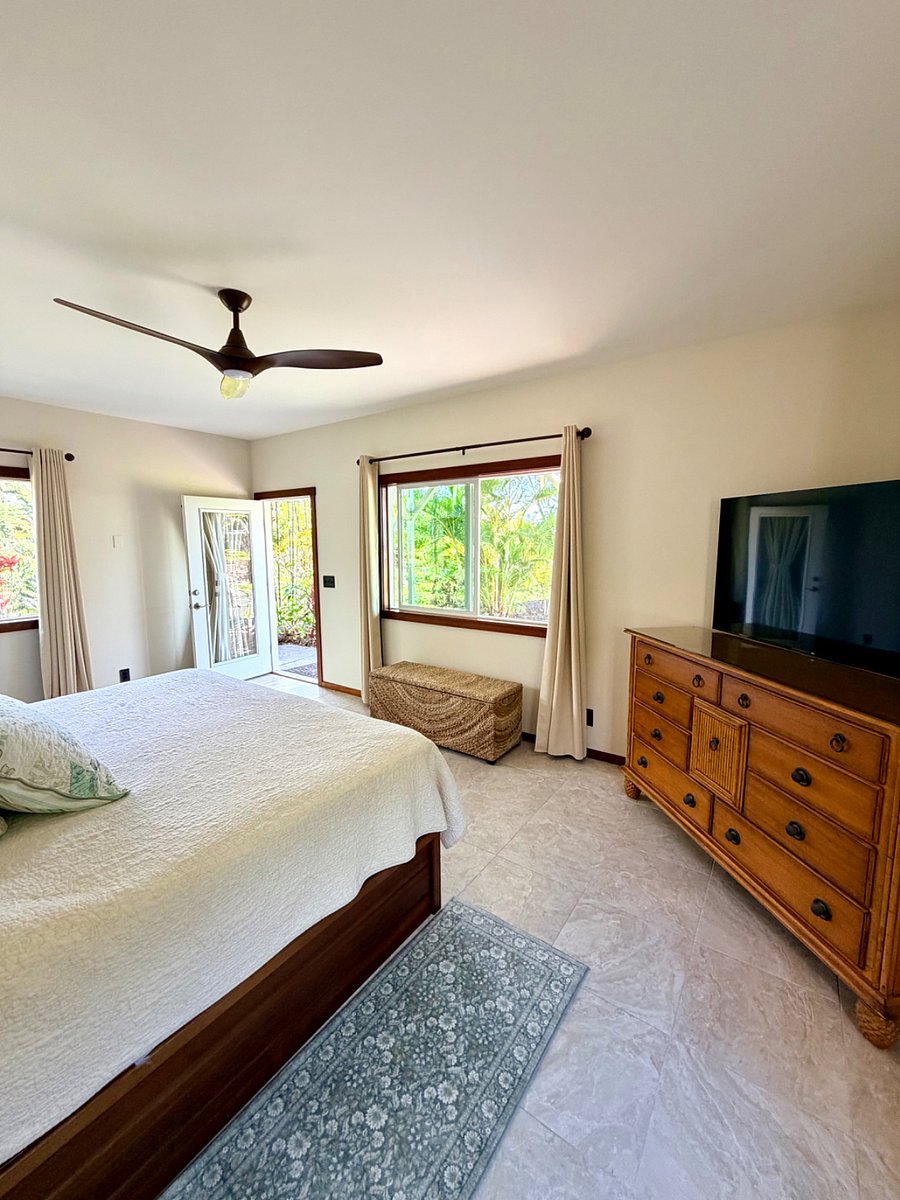 Room opens out to a lanai sitting area that overlooks the garden
