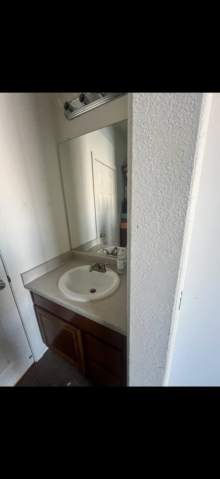 Private sink cabinet and medicine cabinet area in suite
