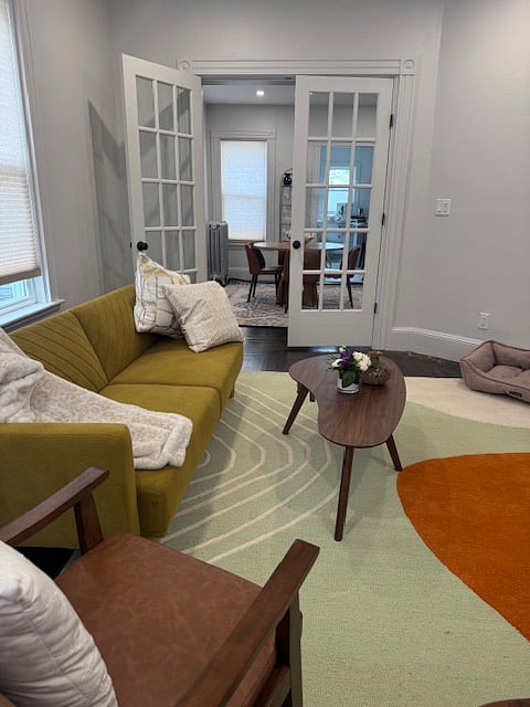 furnished living room with view directly thru dining room to kitchen