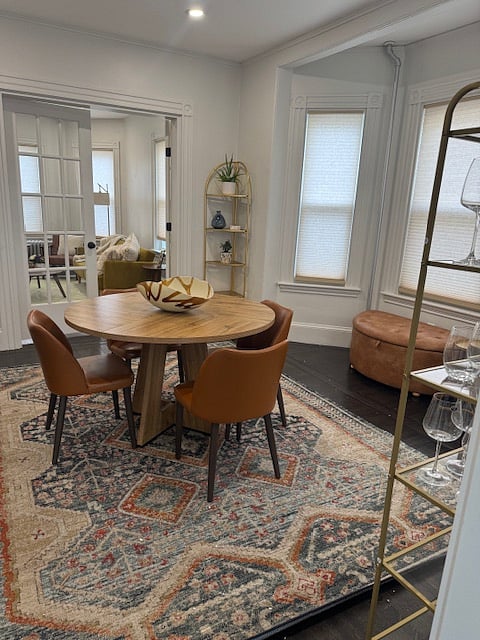 furnished dining room with view into living room.  French doors separating rooms