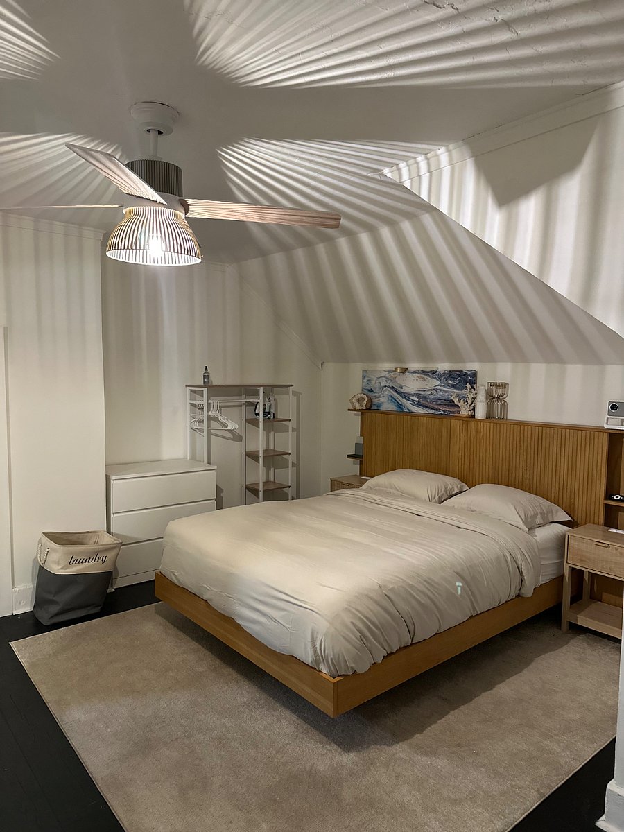 Spacious bedroom with queen size bed and clothes storage