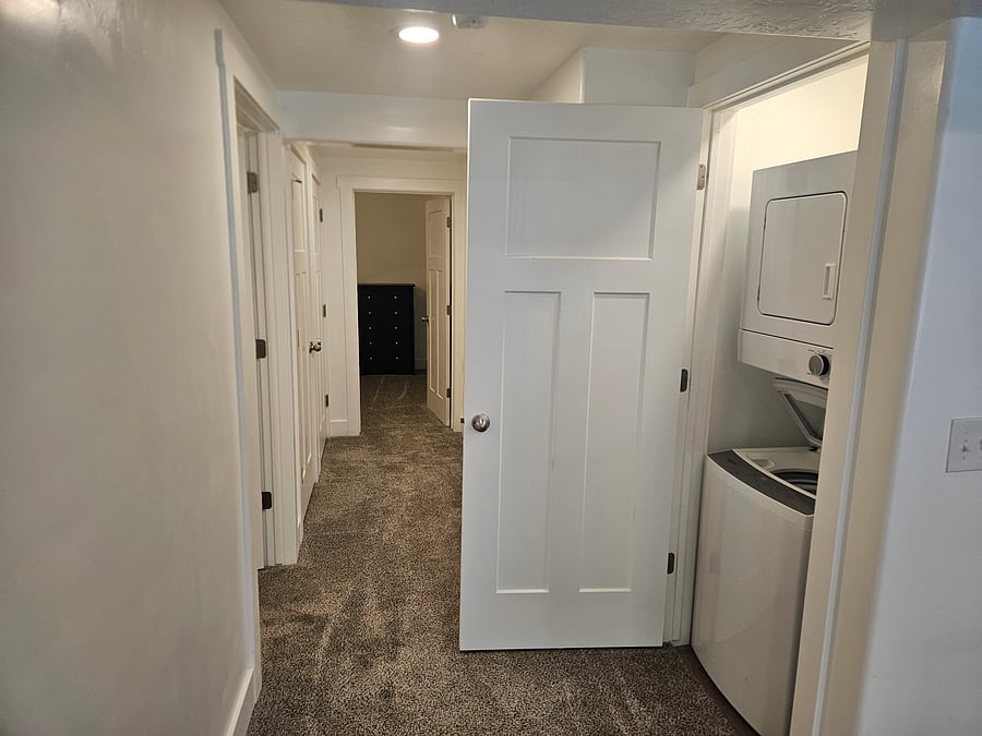 Hallway to bedrooms and under stairs storage.
