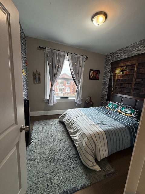 Bedroom 1 includes a Queen sized bed, walk-in closet and themed decor. Window faces North.