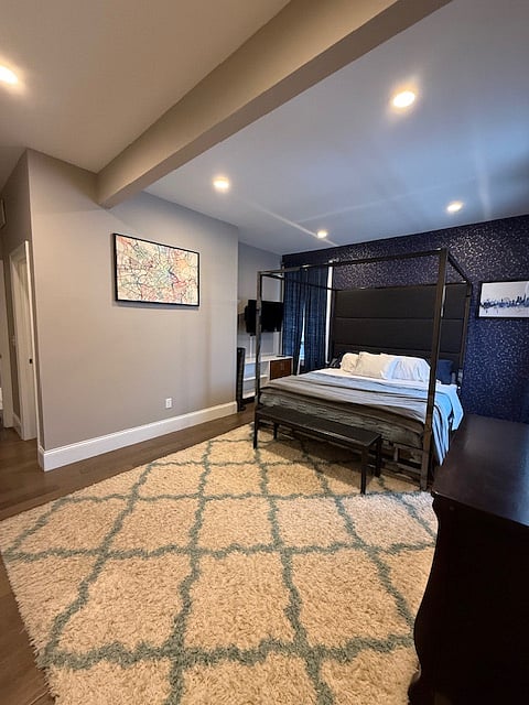 Beautiful framed bed with constellations wallpaper.