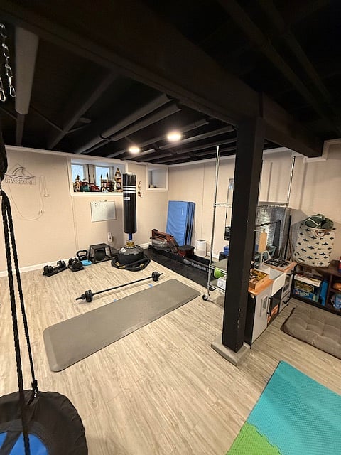 Fitness area mats, yoga mats, rower, bench with bar and weight plates, punching bag, battle ropes, etc.