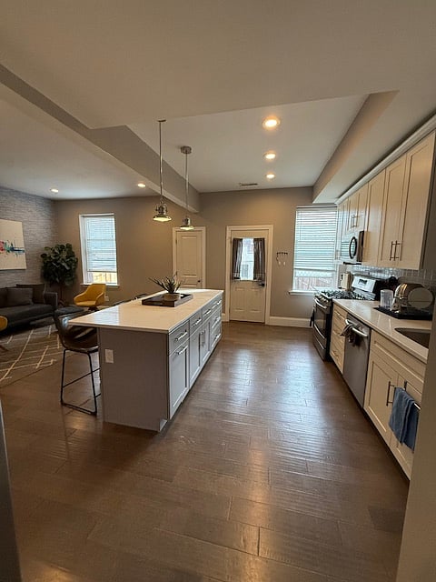 Substantial kitchen counter and cabinet space included with island.
