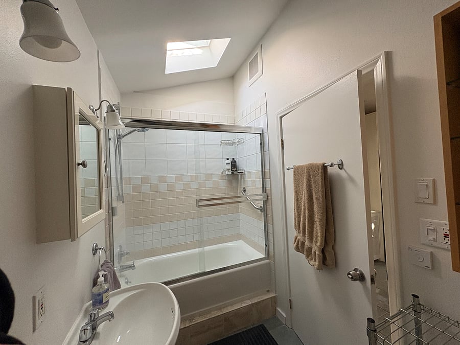 Remote controlled solar skylight over shower/tub.