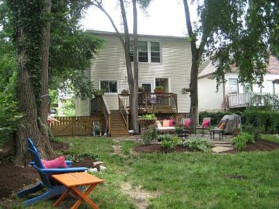 backyard oasis complete with deck, patio, grill, hammock and firepit