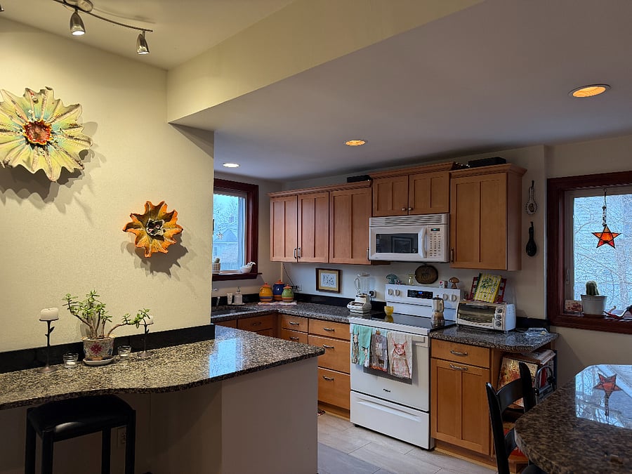 kitchen area complete with serving area, granite countertops and great natural light