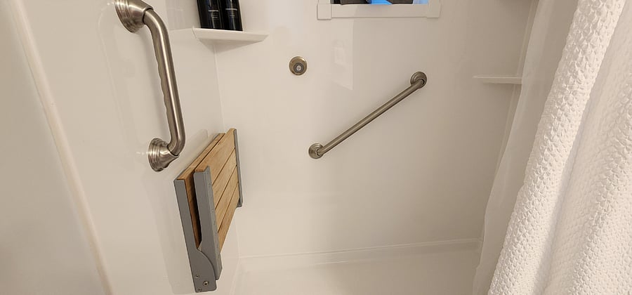Main level bathroom with walk in shower and shower chair