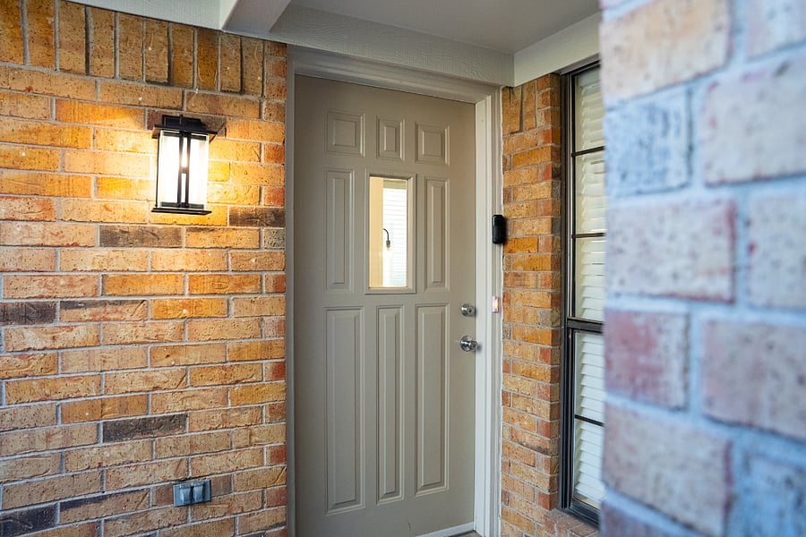 The front door features keyless entry and opens onto a covered porch.