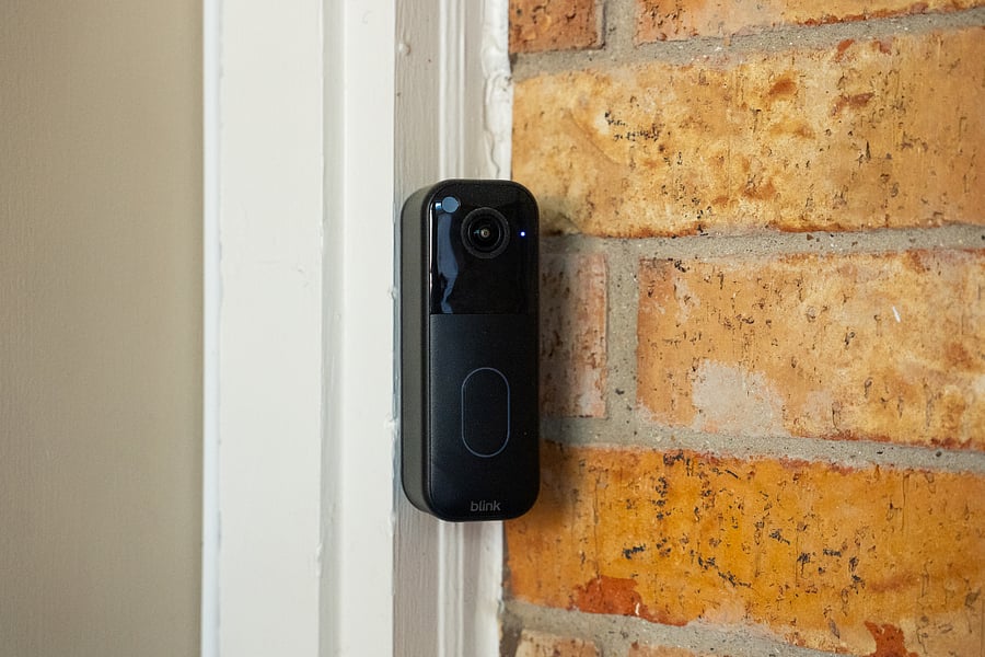 The lighted paths at the front and back of the house feature floodlights, security cameras, a video doorbell, and clearly visible illuminated, reflective house numbers.