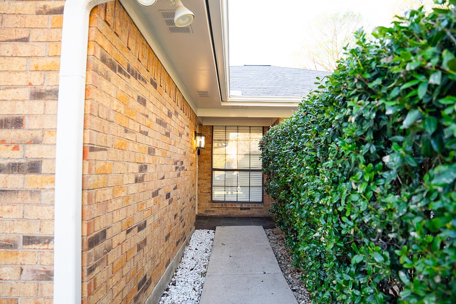 The lighted paths at the front and back of the house feature floodlights, security cameras, a video doorbell, and clearly visible illuminated, reflective house numbers.