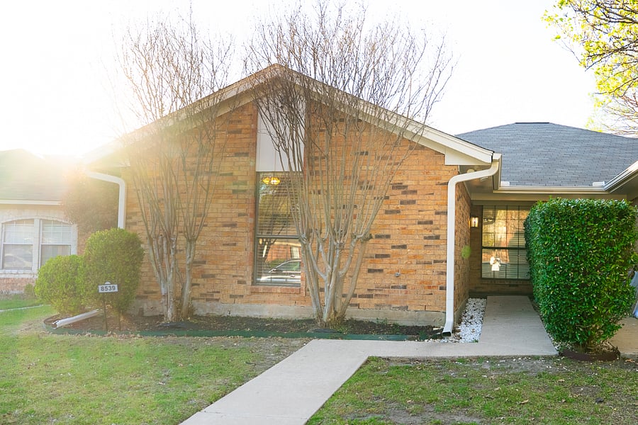 The lighted paths at the front and back of the house feature floodlights, security cameras, a video doorbell, and clearly visible illuminated, reflective house numbers.