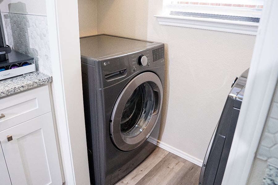 Just off the kitchen, youll find a convenient laundry area with a full-size front-loading washer and dryer.