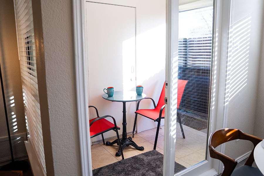Step right off the dining room onto a cozy covered patio, perfect for savoring your morning coffee or unwinding with an evening cup of tea. This inviting outdoor nook lets you sit back, listen to the birds, and enjoy the beautiful weather in comfort and privacy.