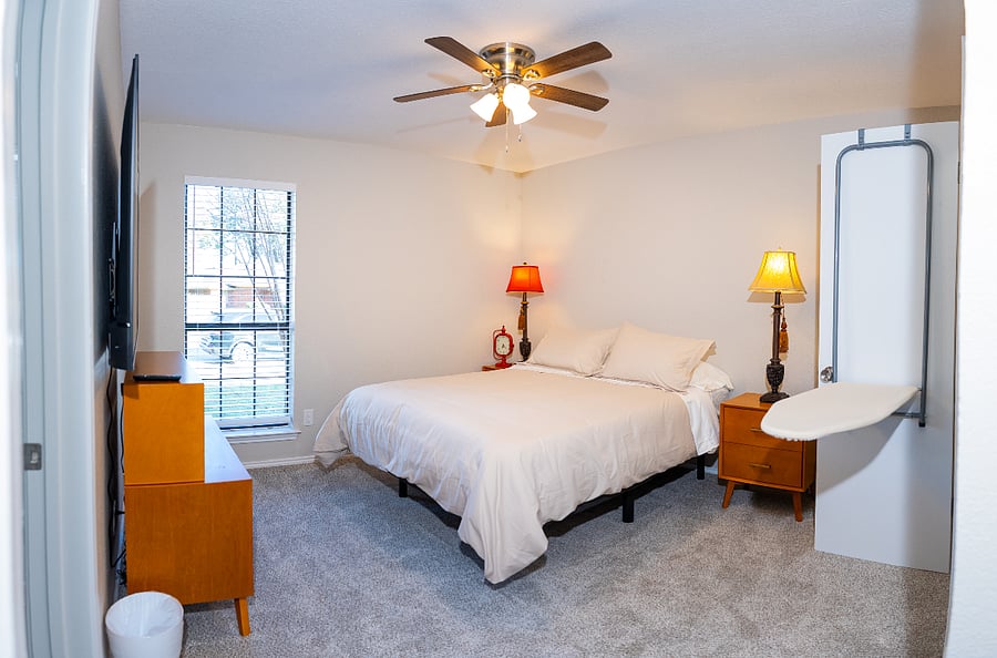 Spacious owners suite featuring a queen-size adjustable bed with zero-gravity and TV-watching settings for customized comfort. The room includes a Smart TV and a private en suite bathroom for added convenience.