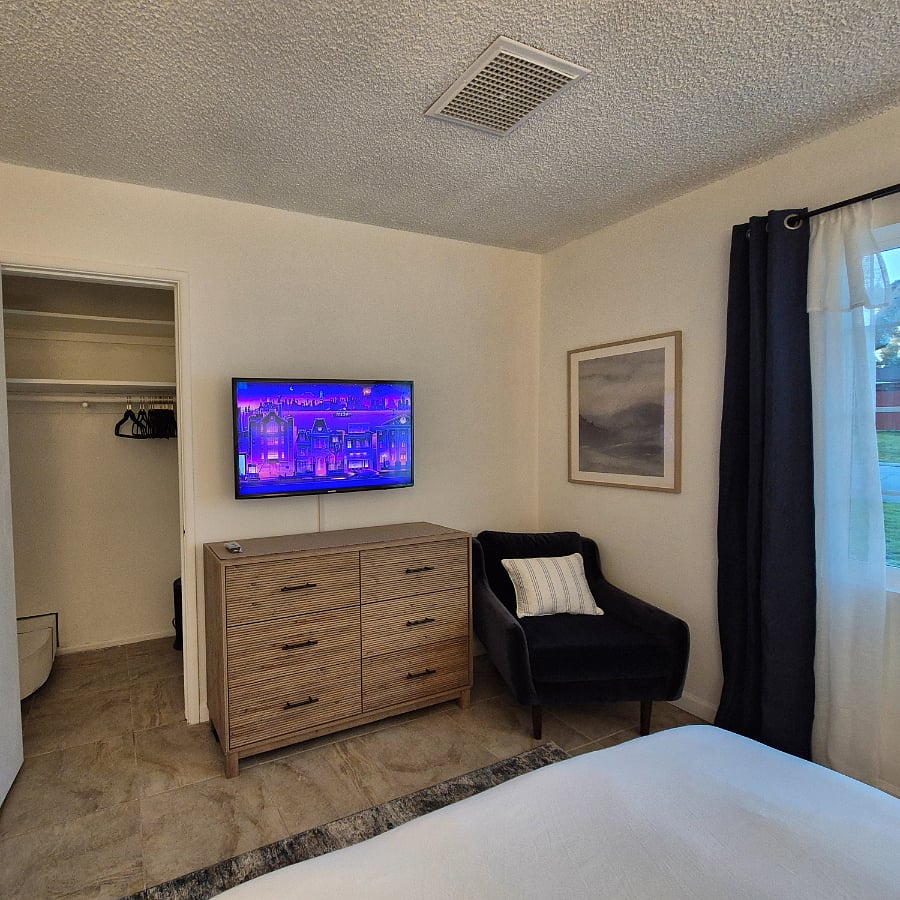 Balckout curtains, smart tv, dresser, reading couch, closet space