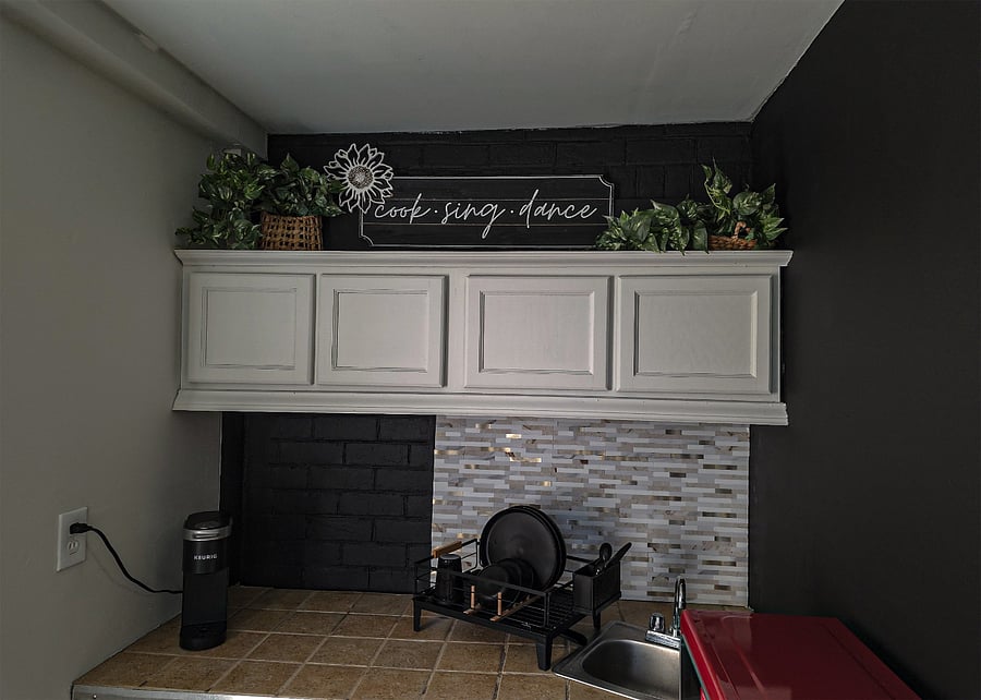 Kitchenette with dishes, Keurig, dishrack and retro microwave.