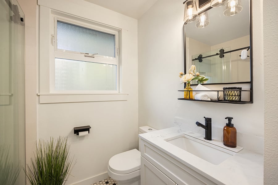 Vanity with storage and a linen closet.