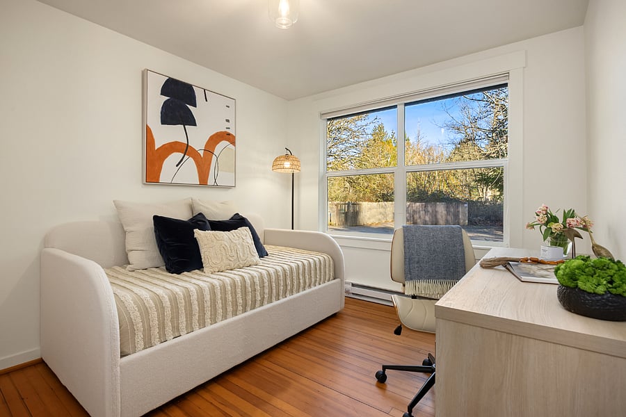 East Facing Bedroom with twin daybed, closet, and work desk. The daybed lifts up for additional storage.