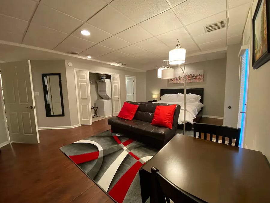 Master Bedroom with King bed, washer/dryer utilities (stacker) in the closet (doors can be closed), artistic reading lamp and comfortable folding-brown sofa (can lay flat to create a futon for a full-size bed/trifold-topper mattress pad in the closet).
Side of bed is lamp/USB phone charging plugs.