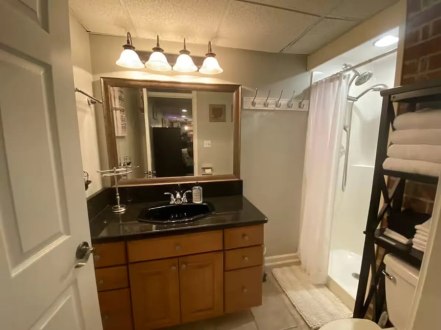 Main bathroom (half-bath/Shower), located just off the living room/common area.
Includes solid granite surface vanity, storage above toilet, shower (adjustable head/hand-sprayer), toilet.
Extra toilet-paper provided, cleaning supplies (underneath vanity)
plus Hair-dryer and 1st-Aid-Kit in the drawers of the sink vanity.