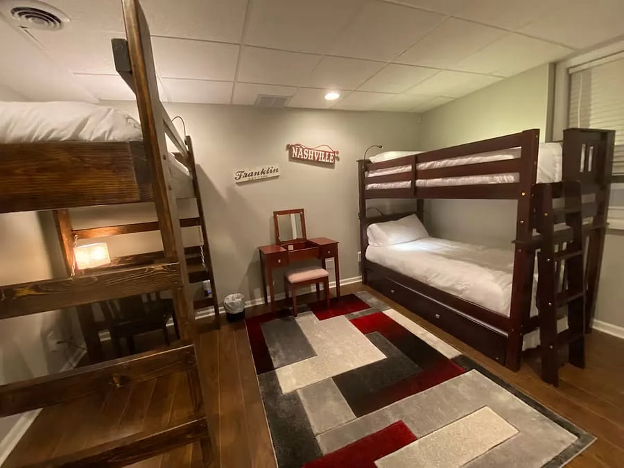 Bunk-bed room, sleeps 3.
Large sturdy loft (on the left), with underneath desktop/lamp work area/chair,
Nice wooden vanity with chair, drawer, left-up center desk (with mirror) for makeup, etc.
Large study bunkbed (on the right).  Soft comfortable mattresses on all the beds.
There is also a trumble-bed underneath that could be used for guests to be able to actually sleep-4 in this bedroom.