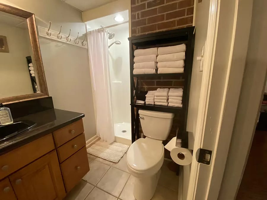 Main bathroom (half-bath/Shower), located just off the living room/common area.
Includes solid granite surface vanity, storage above toilet, shower (adjustable head/hand-sprayer), toilet.
Extra toilet-paper provided, cleaning supplies (underneath vanity)
plus Hair-dryer and 1st-Aid-Kit in the drawers of the sink vanity.