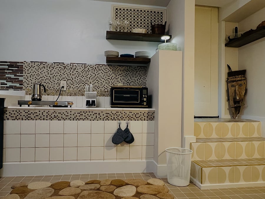 Cooktop and Breville "Designed to do Everything" Oven. Door leads to Laundry Facility.