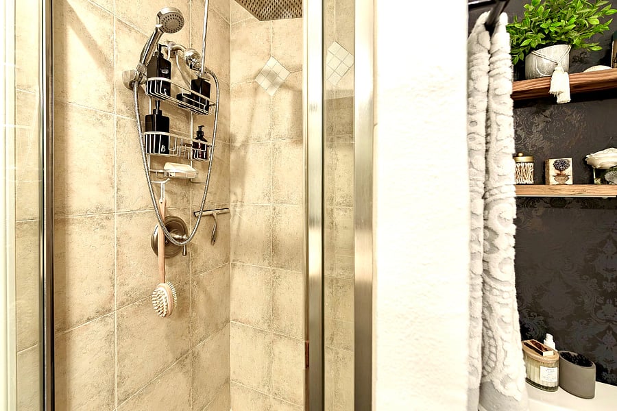 Primary bedroom en-suite bathroom with rain showerhead in standing shower