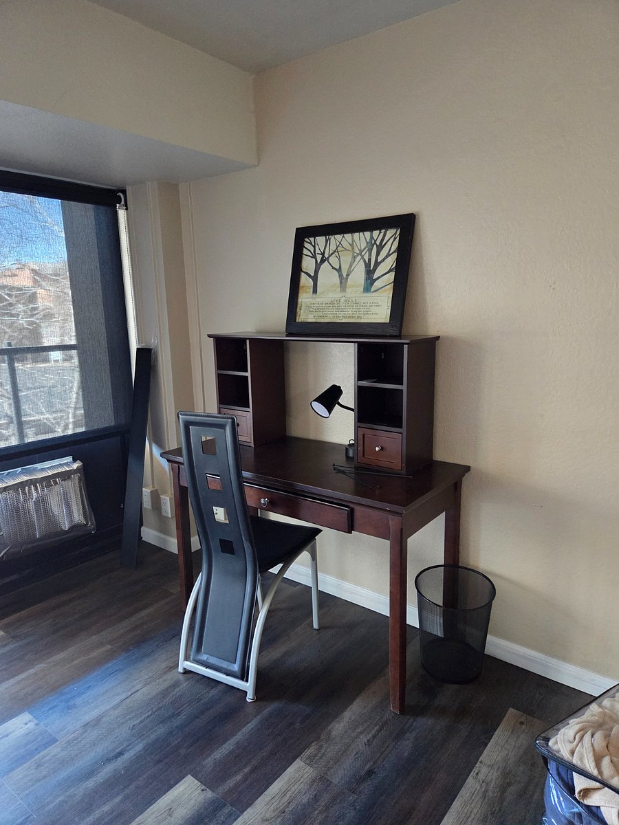 Desk set up in officeCovered drop off entrance and parking lot