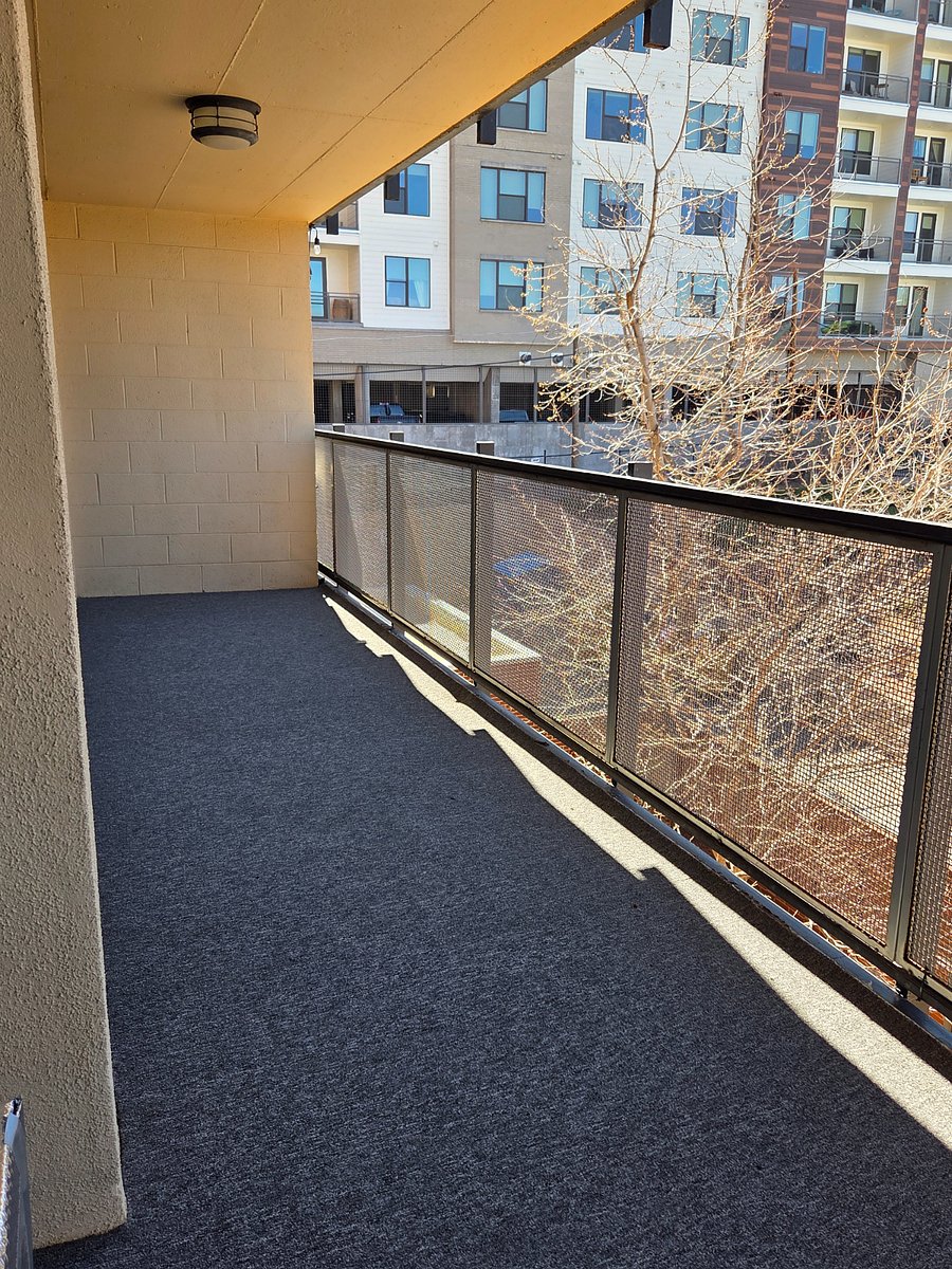 anouther view of the large balcony with 3 slidding doors to walk out from.