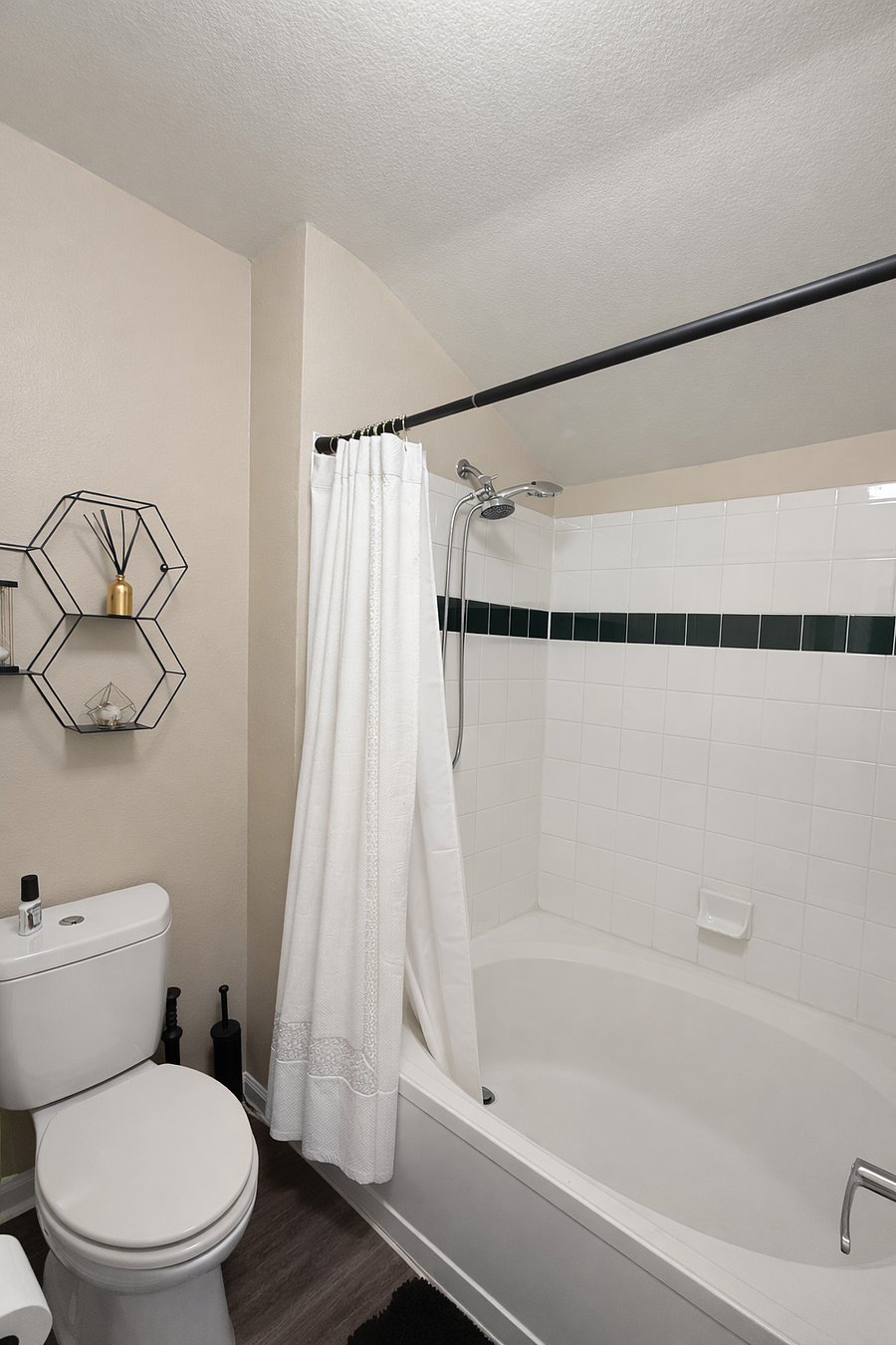 Master bathroom separated from the sink area with a door