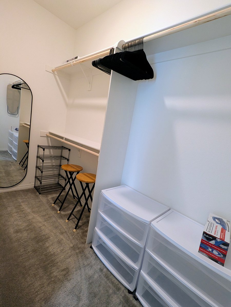 Spacious walk-in closet with full-length mirror