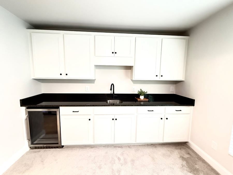 Functional kitchenette with mini fridge and plenty of cabinet space.
