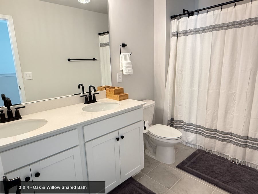 Shared by Cedar & Willowspacious double vanity with modern matte black fixtures.