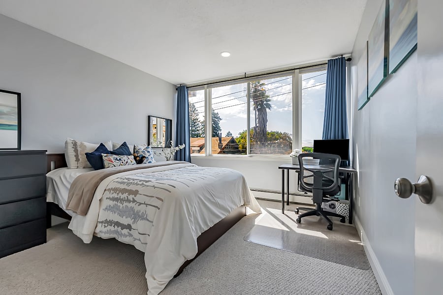 Sizable carpeted bedroom with a view of SF bay